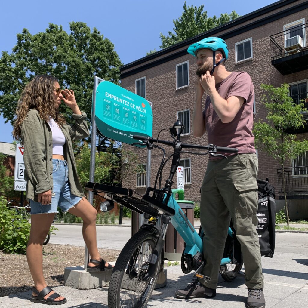 Two LocoMotion members and the Père Ambroise library cargo bike